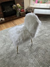 White faux fur accent chair with tapered gold-finished metal legs