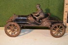 "Arcade Silver Arrow" coupe, 7 7/8", 1900-20, driver, some gold still on tires