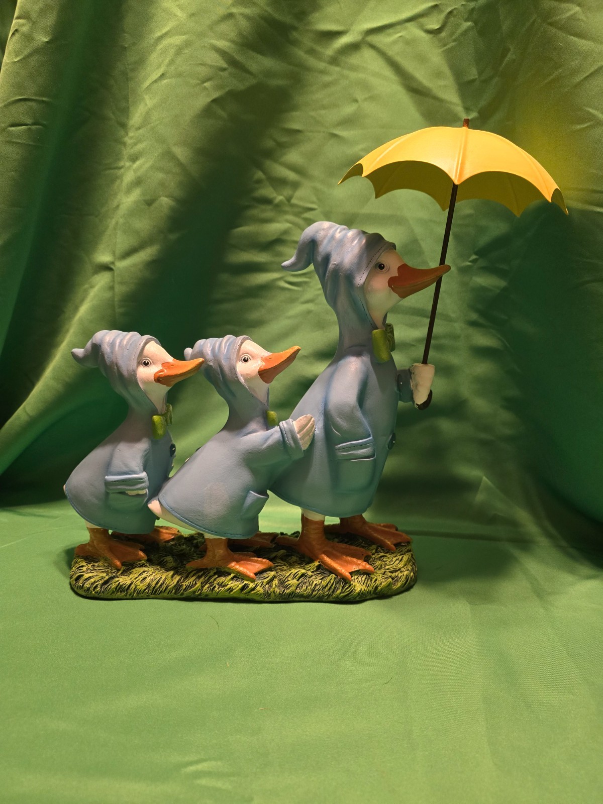 F. A. O. Schwarz resin ducks holding umbrella