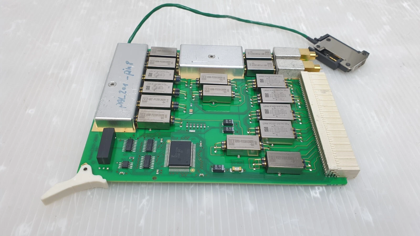 Component side of the Agilent pin board with URM and URT metal-can modules and QFP IC