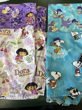 Lot of 4 Scrub Tops Disney Roadrunner Peanuts Dora The Explorer