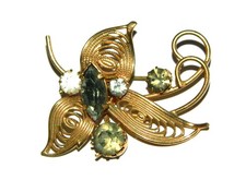 jolie broche  vintage en métal doré et strass