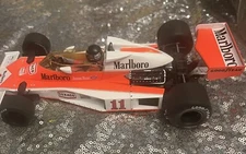 Model car group-McLAREN M23 - #11 MARLBORO McLAREN -  British GP 1976 J. HUNT