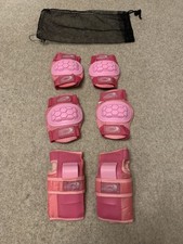 Girls pink Osprey wrist, knee and elbow pads size small with black netting bag