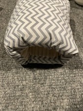 portable breastfeeding arm pillow designed to support a baby's head and neck