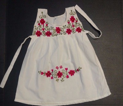 white dress with embroidered flowers