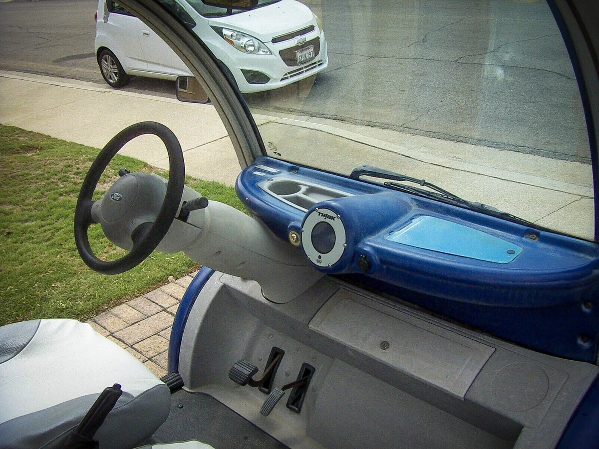blue 2002 Think Neighbor golf cart - dashboard, steering wheel, pedals