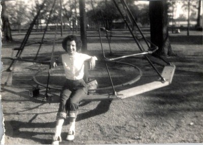 Vintage 1950s Snapshot: Woman on Merry-Go-Round in Casual Blouse & Trousers