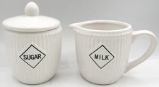 White Ceramic Ribbed Lidded Sugar Bowl & Milk Pitcher Set.