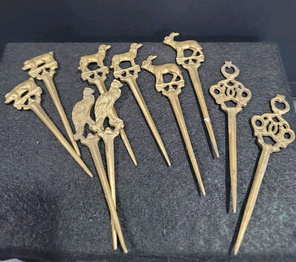 Set of 10 figural brass cocktail picks from the 1960s — the kind of barware detail that makes a home bar look like a film noir set.