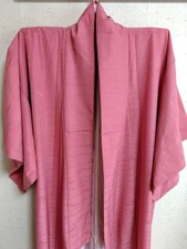 Vibrant pink kimono with a patterned design and basting