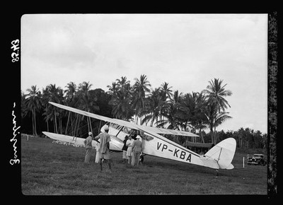 Photo:Zanzibar. Plane alighting. Grounds surrounded by dense palm groves