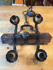 vintage-style chandelier - rustic wrought iron frame and wooden beam, medieval