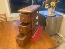 Antique sewing machine cabinet drawers from 1898 in standalone frame