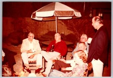 Vtg Color Snapshot Group Men Women Socializing Night Backyard Umbrella 1970s