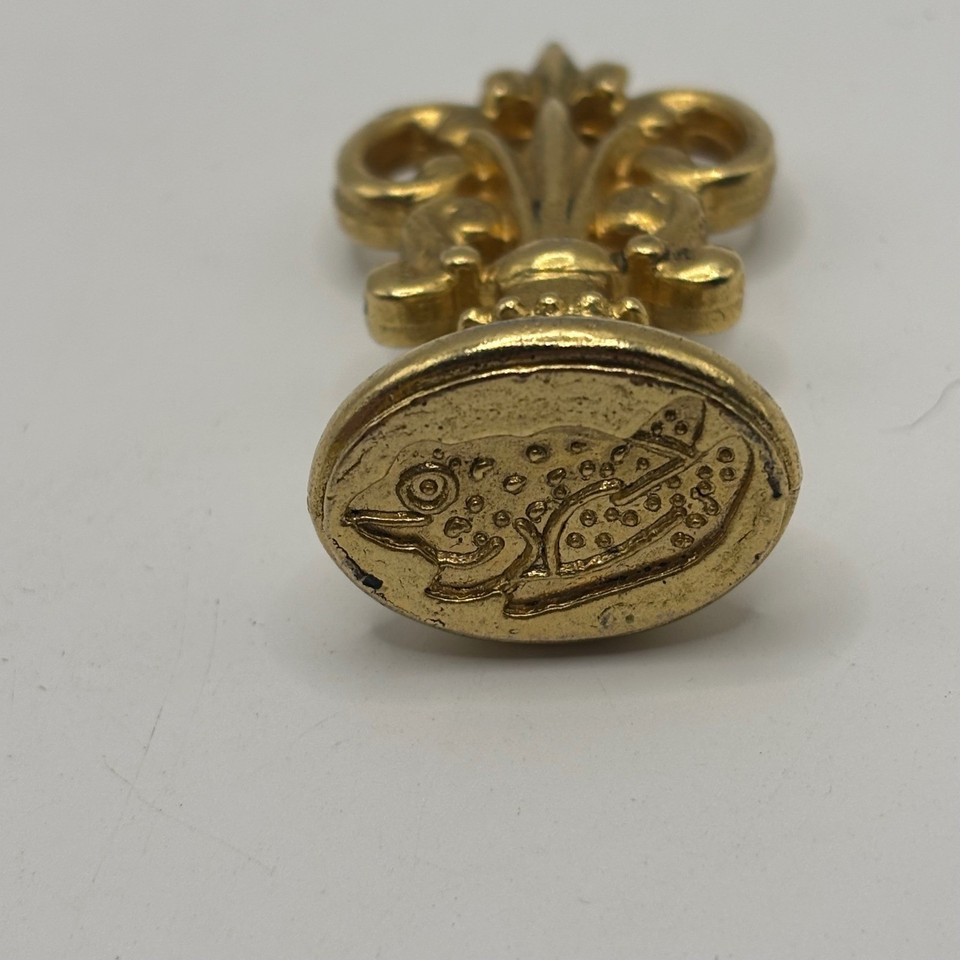 A chunky vintage brass wax seal stamp with a frog motif — the kind of analog ritual object that makes every letter feel like a Victorian decree.