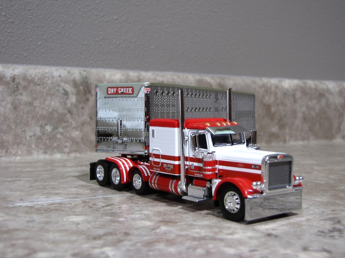 DCP 1/64 Dry Creek Red White Tri-Axle Peterbilt 389 Wilson