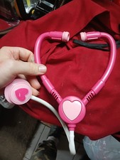 pink toy stethoscope designed for children's pretend play medical kits.