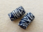 ANTIQUE 2 PCS TUBE SHAPE BLACK GLASS TRADE BEADS W/ WHITE ANIMAL PATTERN — photo 1
