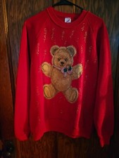 vintage 1980s red Christmas sweatshirt featuring a teddy bear graphic.