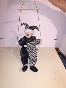 porcelain clown doll on swing