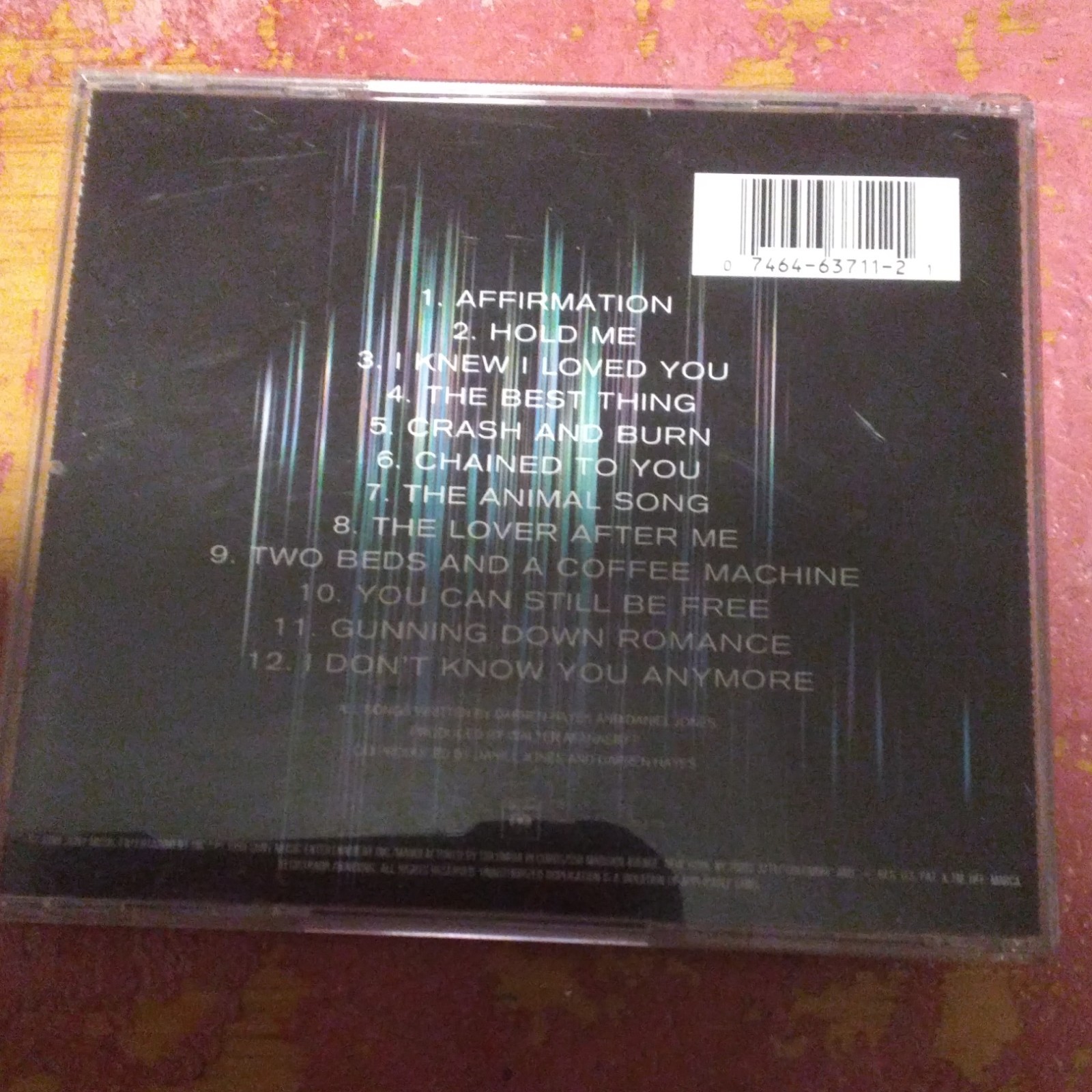 CD back cover of "Affirmation" by Savage Garden with song titles in white text and Columbia 63711 label.