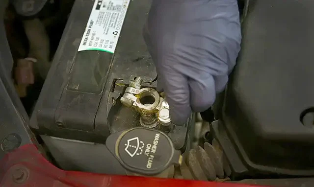 Removing a battery terminal.