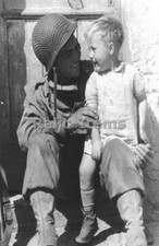 WW2 Picture Photo US Army Soldier smiles with a young boy France 1944 0449