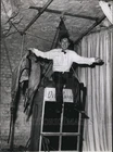 Press Photo Dill - Russell sitting atop the tank holding the jacket - KSG07891