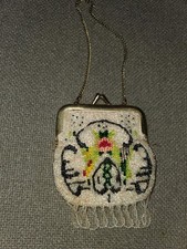 This vintage unbranded beaded purse features intricate beadwork with a floral