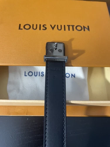 Black Louis Vuitton bracelet with silver hardware and subtle monogram pattern, displayed on yellow box with matching dust bag.