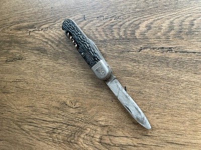 Vintage Pocket Knife with Textured Handle, Small Blade, and Corkscrew