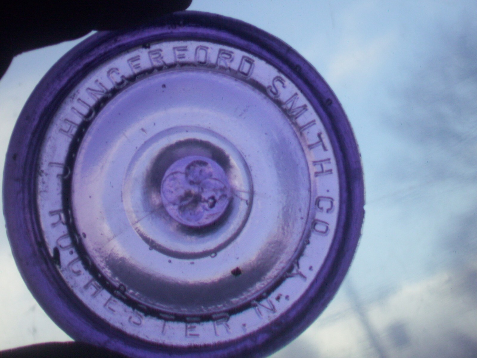 Dark purple J, Hungerford Smith co. Rochester, N. Y. glass top canning jar lid