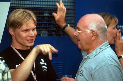 Mika Salo talks with ITV F1 TV commentator Murray Walker as his IT- Old Photo