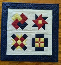 Handmade Quilted Wall Hanging or Table Topper in navy, red  yellow