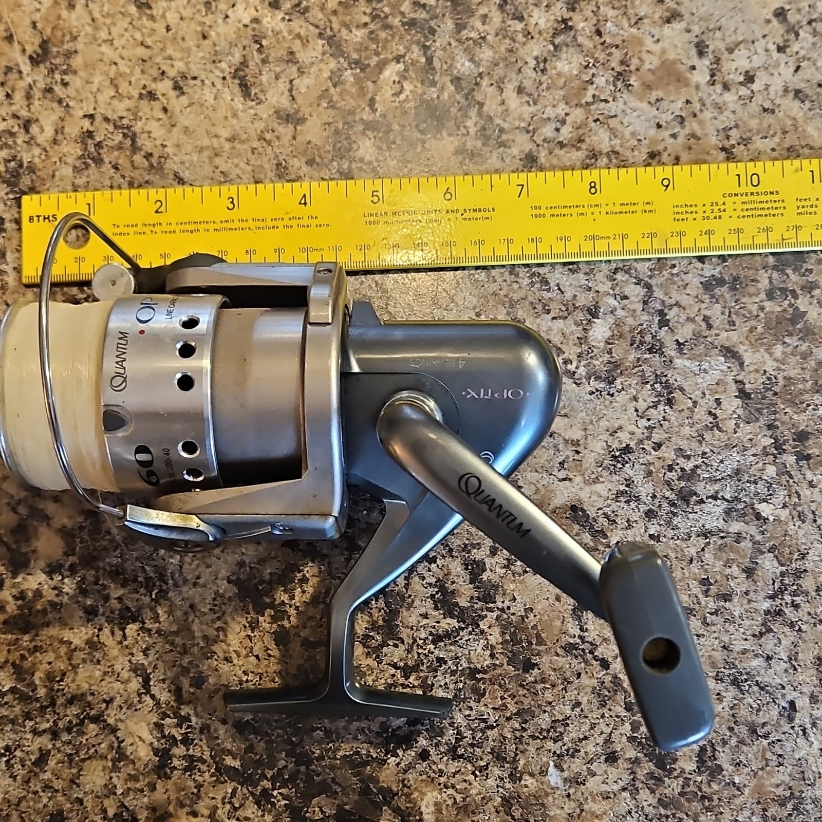 Quantum Optix 60 Spinning Reel Silver Black 4 Ball Bearings 340yd 30lb Line