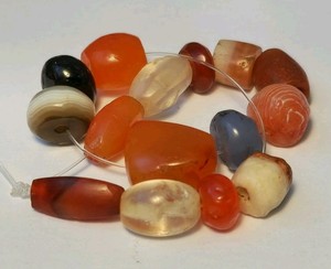 A RARE STRAND OF 15 ANCIENT AGATE, CARNELIAN, GARNET, ROCK CRYSTAL BEADS