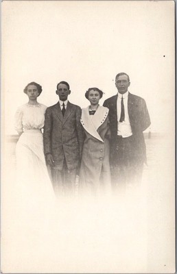 c1910s Real Photo RPPC Postcard Two Young Couple Outdoors - Weird, Ghostly Image