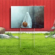 A white ghost holding a carved pumpkin Halloween yard sign