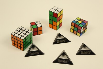 4 Rubix Cubes With Display Stands