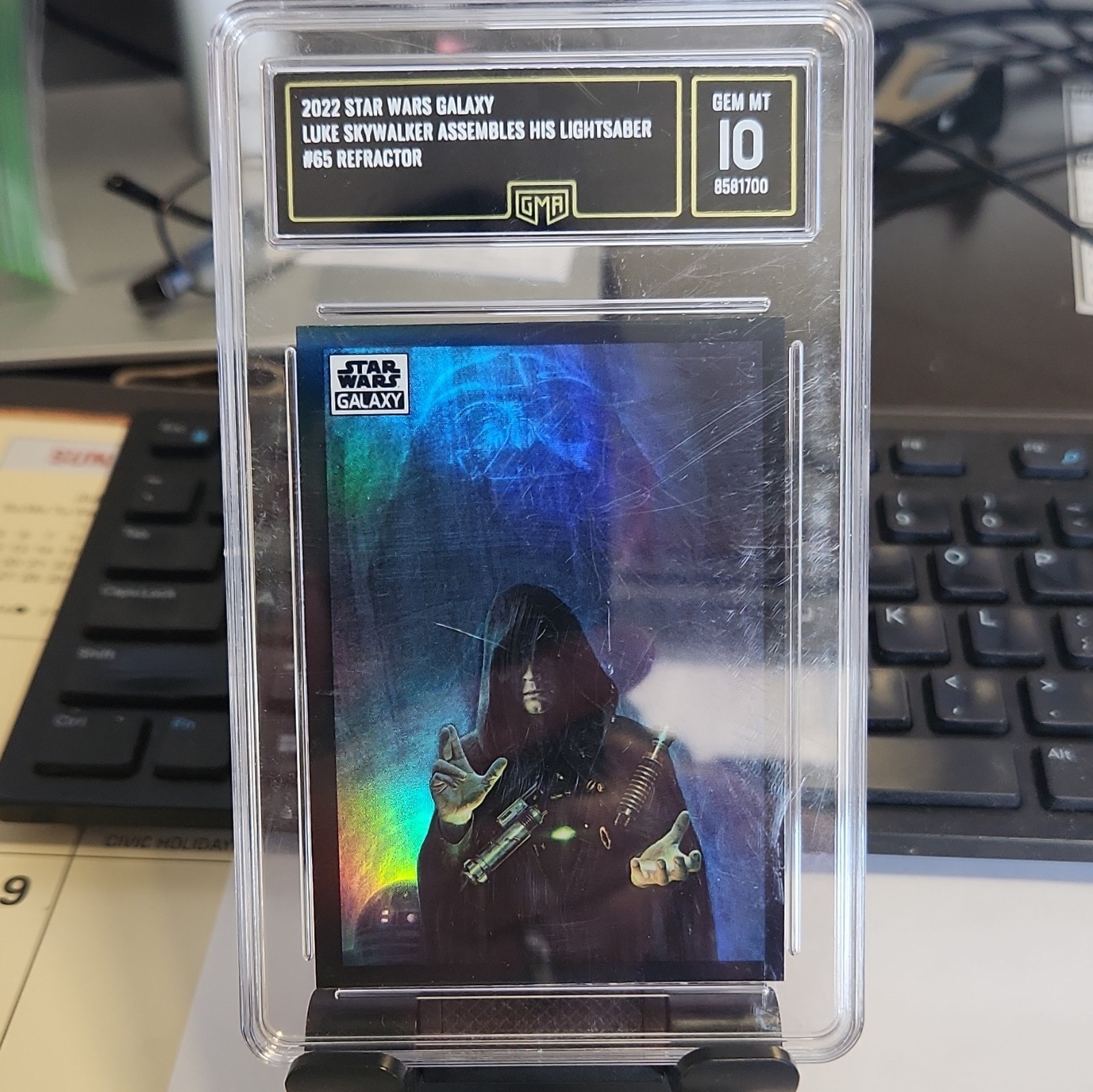 Luke Skywalker Assembles His Lightsaber #65 Star Wars 2022 Topps Galaxy Chrome trading card — raw and PSA graded price guide