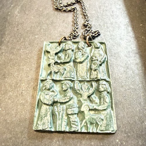 Byzantine green pendant depicting religious figures carved into a stone tile