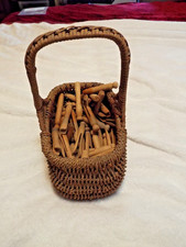 Lot of Vintage Wooden Clothes Pins In Wicker Basket