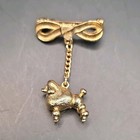 Vintage Gold Tone Metal Bow Brooch Pin Dangle Poodle Charm Animal Theme No Stone — photo 1