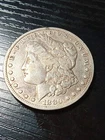 1880-CC 8/7 silver Morgan dollar. Fine. Silver grey. No reserve.