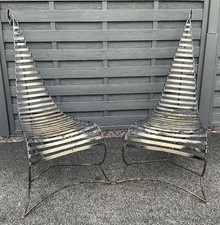 Pair designer André Dubreuil Decorative Arts metal Spine chairs. marked 11
