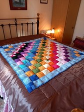 A New handknitted rainbow blanket measuring 46 by 46 inches