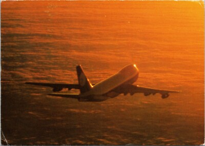 Lufthansa Boeing 747 flying above clouds