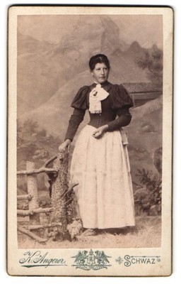 Photograph Kaspar Angerer, Schwaz in Tyrol, woman in costume in front of a picturesque pen 