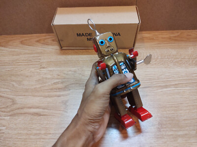 Vintage retro robot litho tin. Gold sparky fire eyes robot